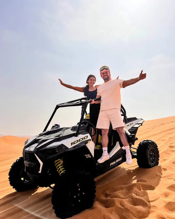 Couple with a Polaris RZR dune buggy on a Dubai desert safari — guest photo 1