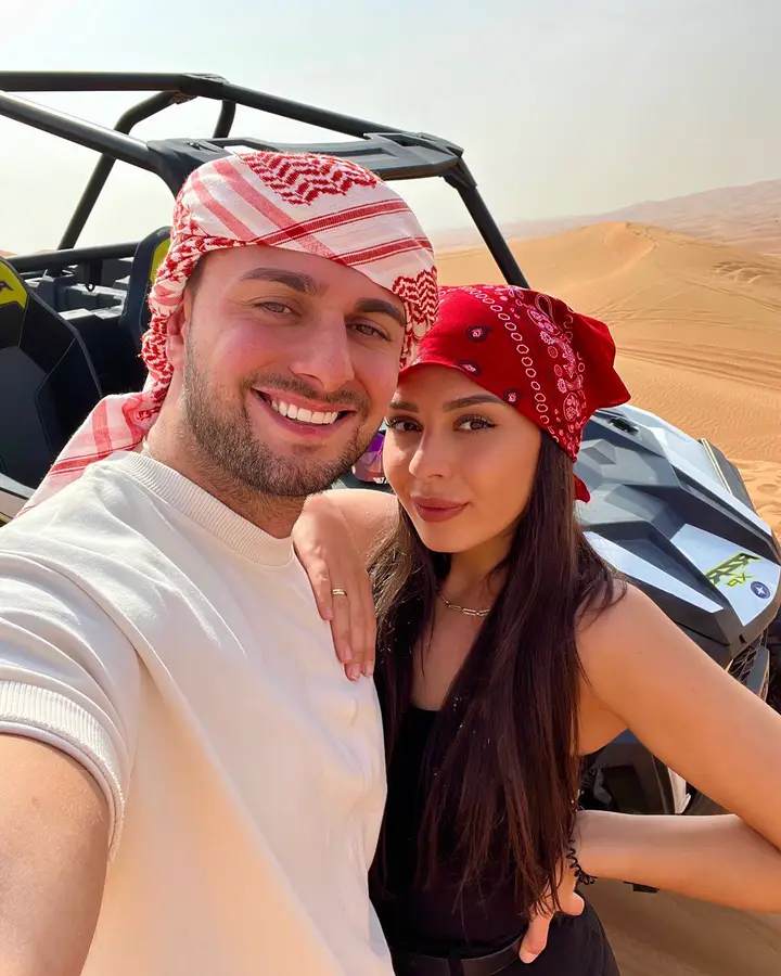 Couple with a Polaris RZR dune buggy on a Dubai desert safari — guest photo 3
