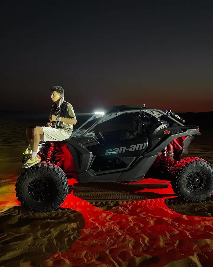 Dune buggy with red underglow on a night Dubai desert safari — guest photo 1
