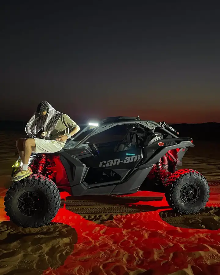 Dune buggy with red underglow on a night Dubai desert safari — guest photo 2