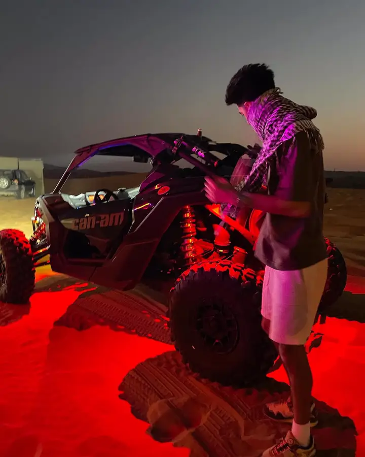 Dune buggy with red underglow on a night Dubai desert safari — guest photo 3