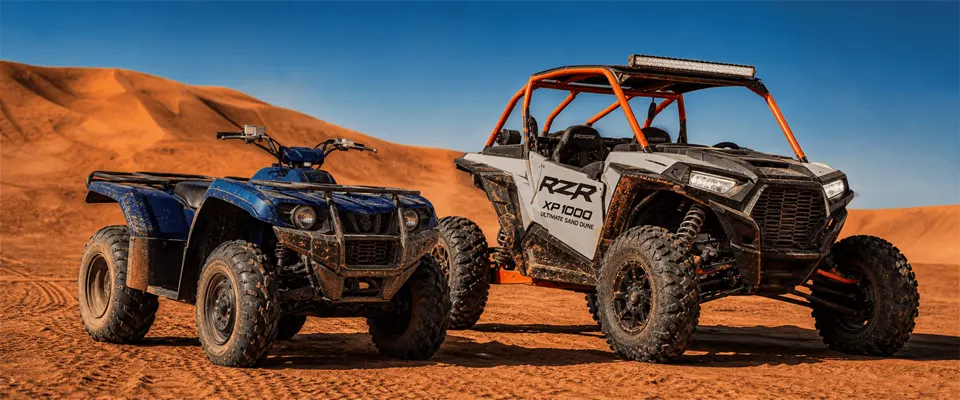 Dune buggy and Yamaha quad bike lined up on the Lahbab dunes near Dubai