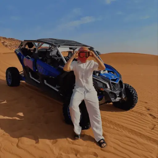 4-seater Can-Am X3 dune buggy with a family group in the Dubai desert