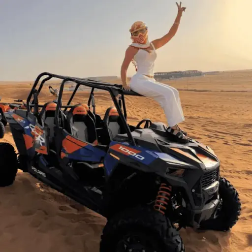 4-seater Polaris RZR dune buggy with a family on the Lahbab dunes