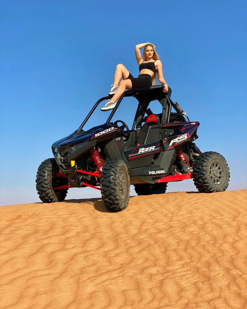 Polaris RZR dune buggy parked on a dune crest